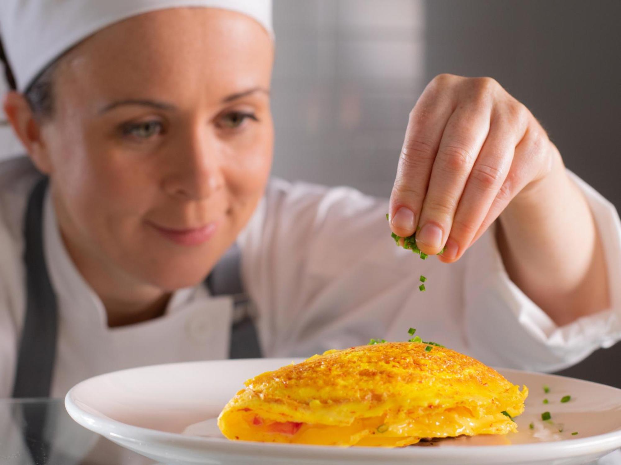 Otl Gouverneur Saguenay Exterior photo A chef seasoning a dish